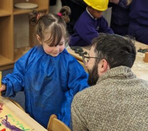 Nursery child smiling at parent